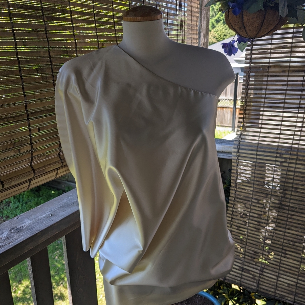 Off the shoulder satin finish top .